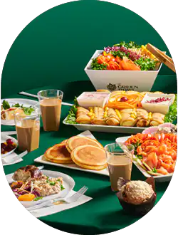 Green Bowl brunch spread with salads, bagels and drinks